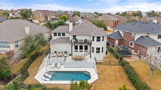 back of house with a balcony, an outdoor living space, a fenced in pool, and a patio