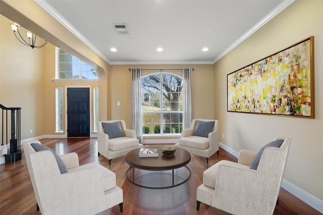 sitting room featuring hardwood / wood-style floors, crown molding, and plenty of natural light