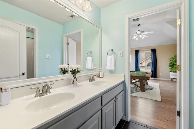 bathroom with hardwood / wood-style flooring, vanity, pool table, and ceiling fan