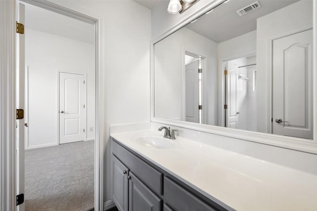 bathroom with baseboards, visible vents, and vanity