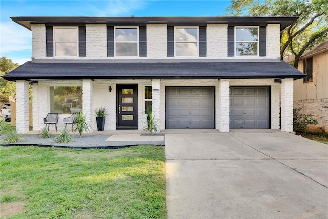 view of front facade featuring a garage, a front lawn, and covered porch