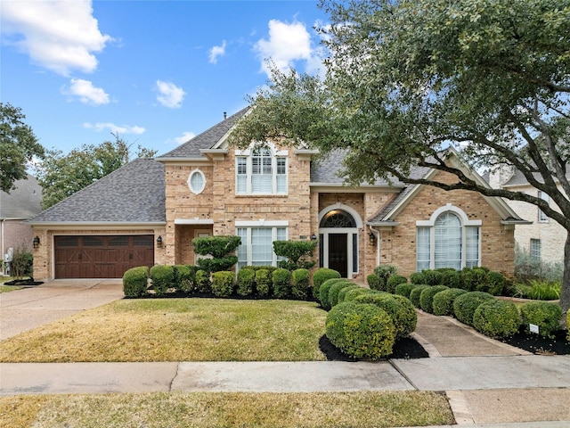 view of front of home featuring a garage and a front yard