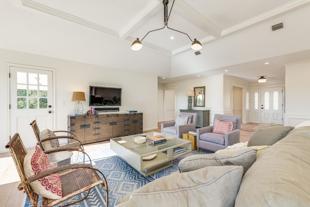 living room with ornamental molding, a healthy amount of sunlight, beam ceiling, and hardwood / wood-style floors