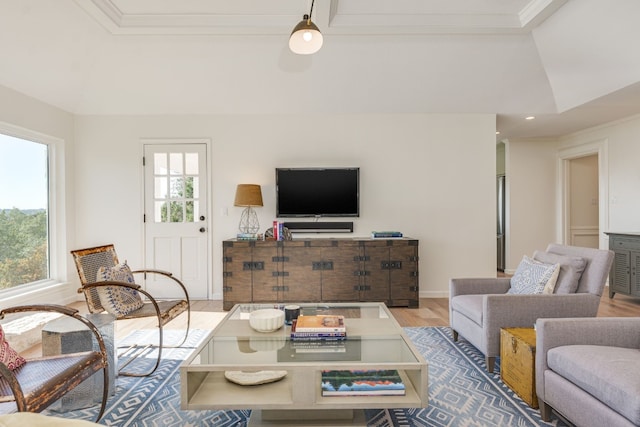 living room with crown molding and light hardwood / wood-style flooring