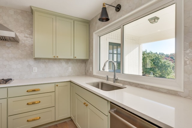 kitchen with wall chimney exhaust hood, stainless steel appliances, sink, and backsplash