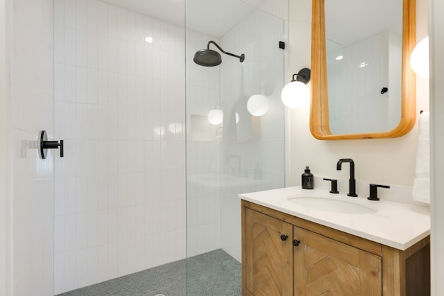 bathroom featuring vanity and a tile shower