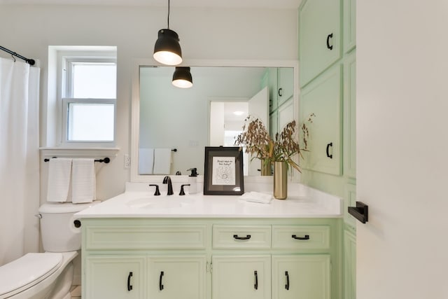 bathroom featuring vanity, curtained shower, and toilet