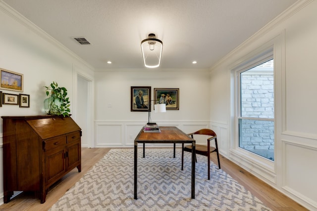 home office featuring crown molding, a textured ceiling, and light wood-type flooring