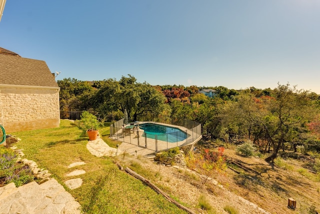 view of swimming pool with a lawn