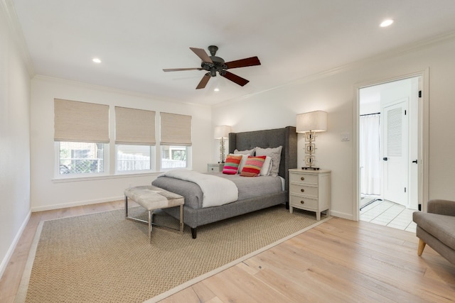 bedroom with crown molding, ceiling fan, and light hardwood / wood-style flooring