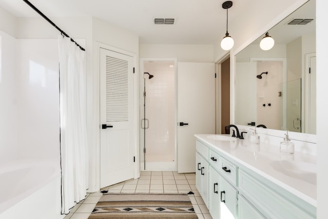 bathroom featuring tile patterned flooring, an enclosed shower, and vanity