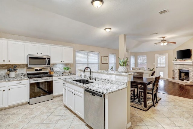 kitchen with white cabinetry, sink, and appliances with stainless steel finishes