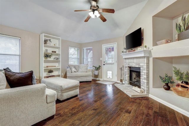 living room with ceiling fan, a fireplace, lofted ceiling, and dark hardwood / wood-style flooring