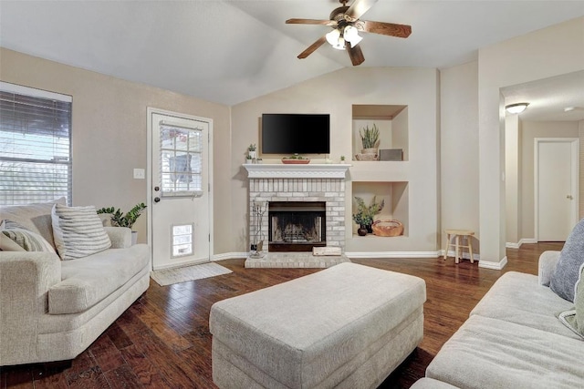 living room featuring dark hardwood / wood-style flooring, a fireplace, lofted ceiling, and ceiling fan