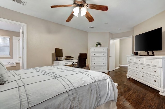 bedroom featuring ensuite bath, dark hardwood / wood-style floors, and ceiling fan