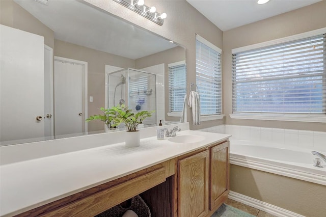 bathroom featuring shower with separate bathtub and vanity