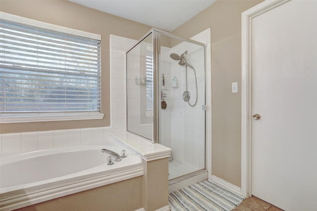 bathroom featuring tile patterned flooring and independent shower and bath