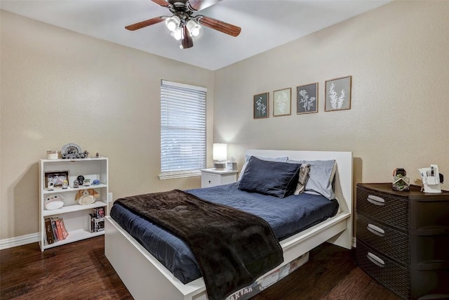 bedroom with dark hardwood / wood-style flooring and ceiling fan