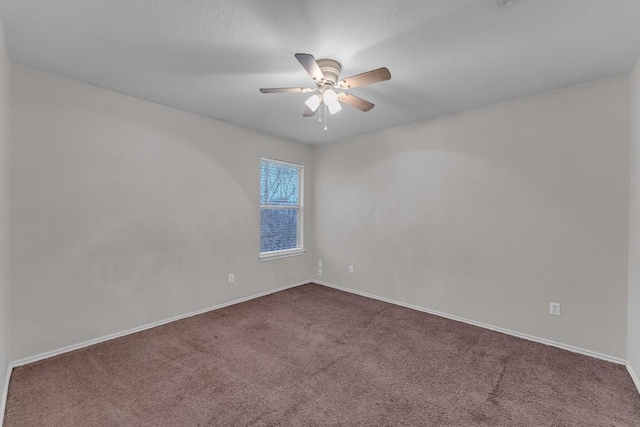 empty room with ceiling fan, carpet floors, and a textured ceiling