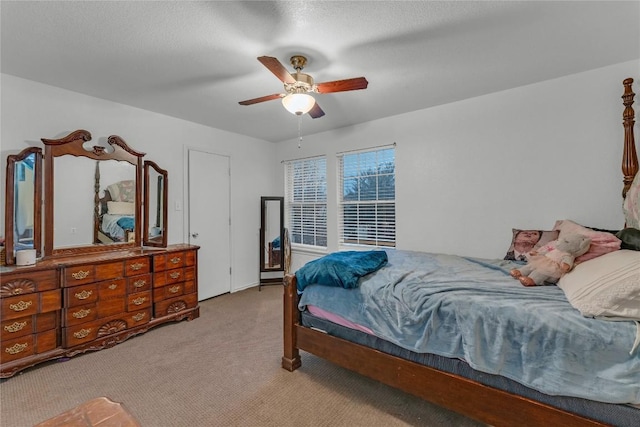 bedroom featuring light colored carpet and ceiling fan