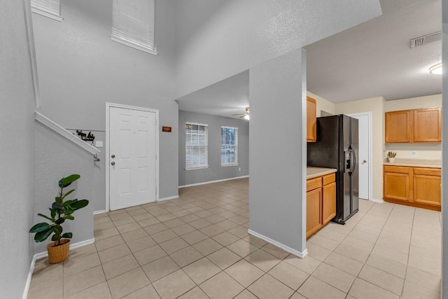 entryway featuring light tile patterned floors and ceiling fan