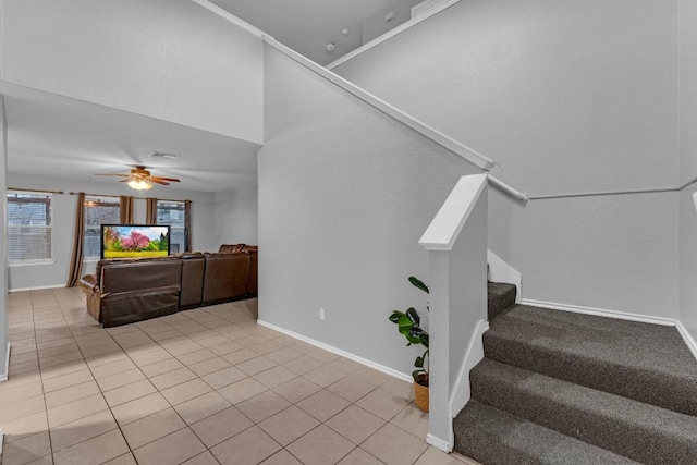 stairway with tile patterned floors and ceiling fan