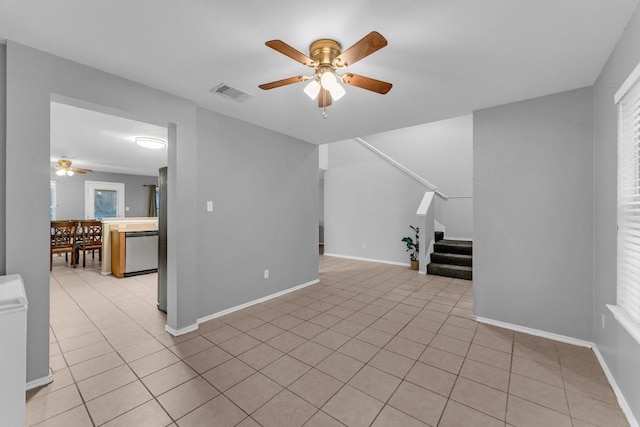 unfurnished living room with light tile patterned floors and ceiling fan