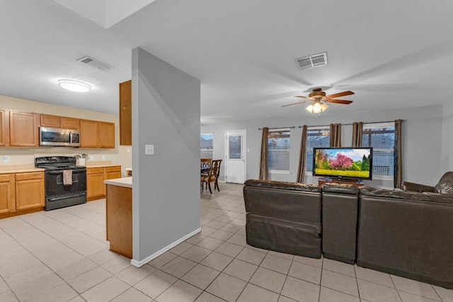 interior space featuring black electric range oven, light tile patterned floors, and ceiling fan