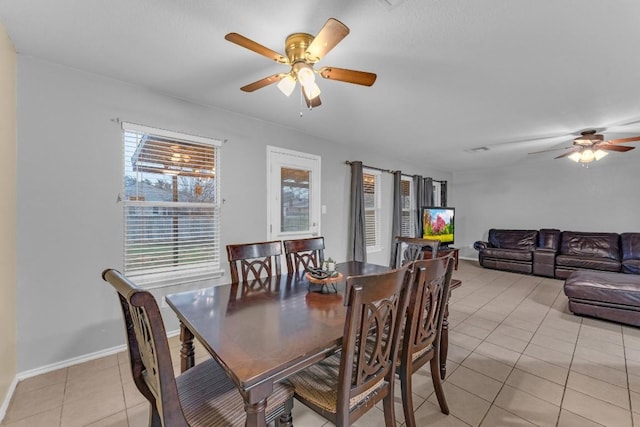 dining area featuring light tile patterned floors and ceiling fan