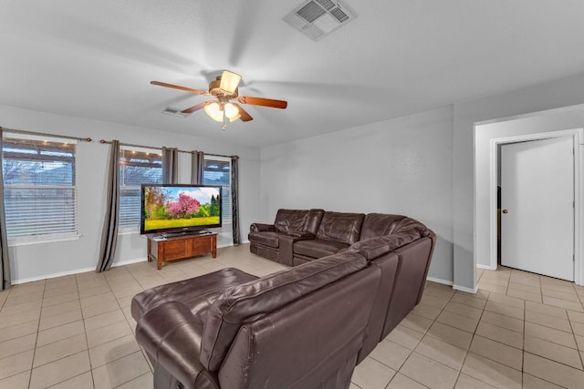 tiled living room with ceiling fan