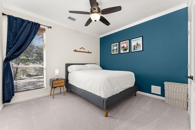 carpeted bedroom featuring crown molding and ceiling fan