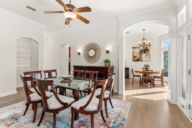 dining area with ornamental molding and light wood-type flooring