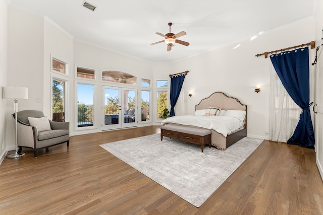 bedroom with french doors, access to outside, ornamental molding, ceiling fan, and hardwood / wood-style floors