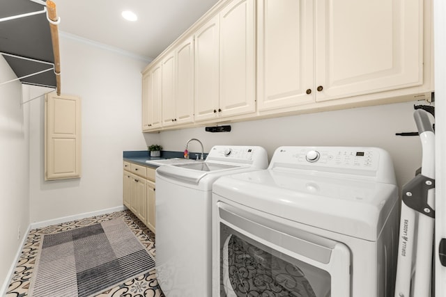 laundry area with sink, ornamental molding, washing machine and dryer, and cabinets