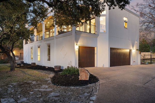 view of front facade with a garage and a balcony