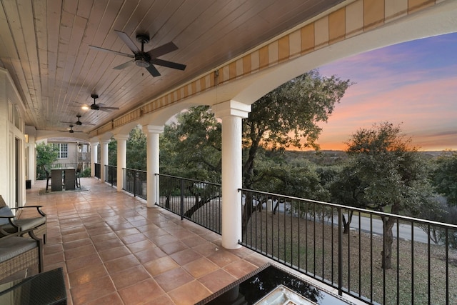 patio terrace at dusk featuring ceiling fan