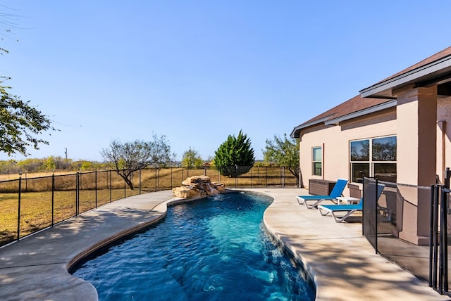 view of swimming pool with a patio and pool water feature