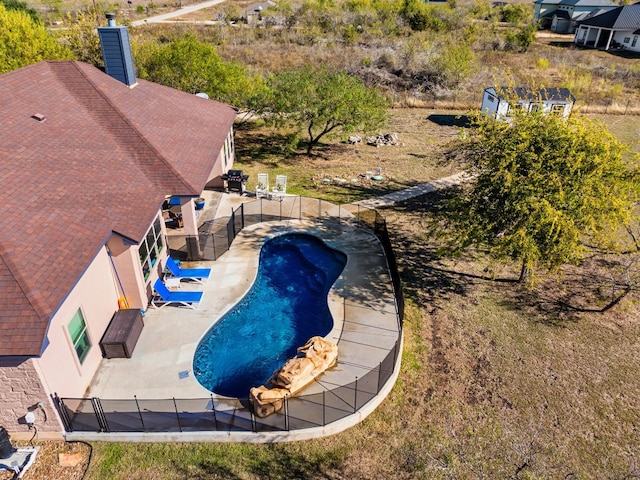 view of pool with a fenced in pool, a patio area, and fence