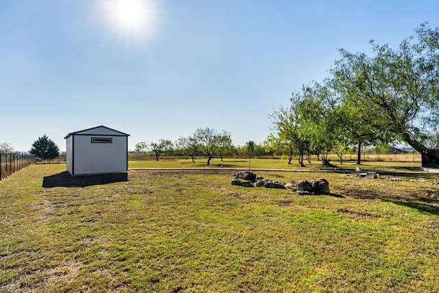 view of yard with a rural view and a shed