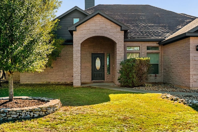 property entrance with a yard