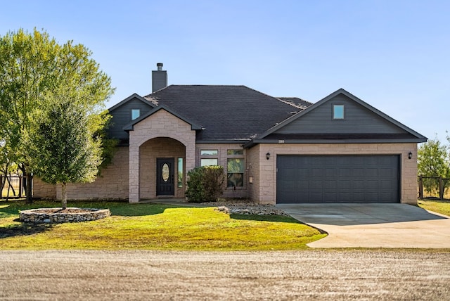 view of front of home featuring a garage and a front yard