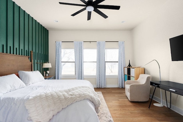 bedroom with ceiling fan and light hardwood / wood-style floors