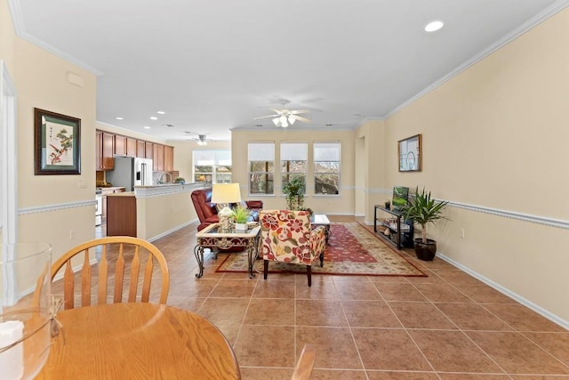 dining space with crown molding, ceiling fan, and light tile patterned floors