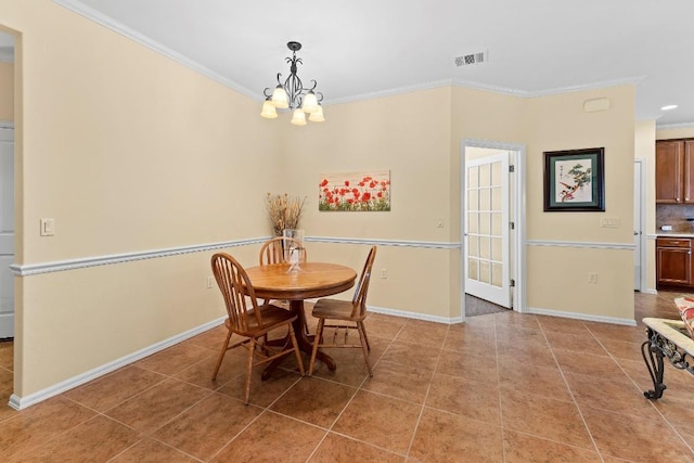 dining space featuring a notable chandelier, ornamental molding, and light tile patterned flooring