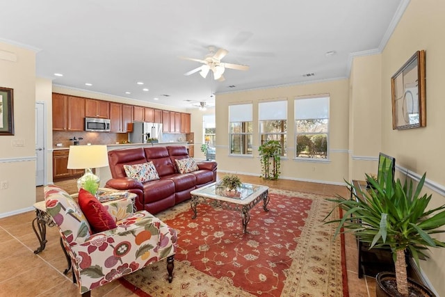 living room featuring light tile patterned flooring, ceiling fan, and crown molding