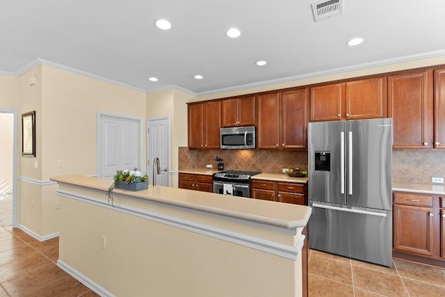 kitchen with light tile patterned floors, ornamental molding, an island with sink, stainless steel appliances, and decorative backsplash