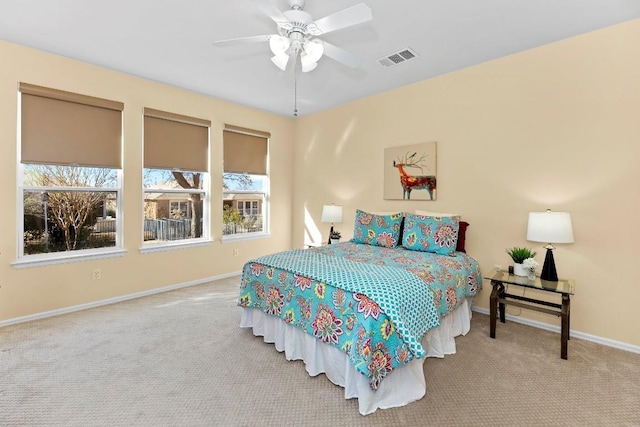 bedroom with light colored carpet and ceiling fan