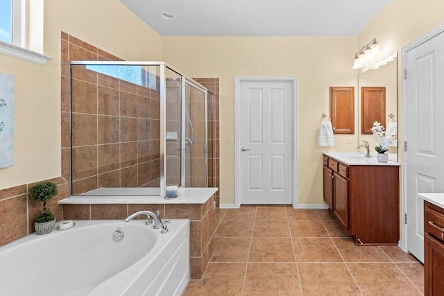 bathroom with vanity, tile patterned floors, and plus walk in shower