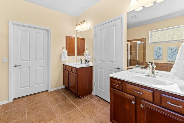 bathroom with tile patterned flooring, vanity, and an enclosed shower