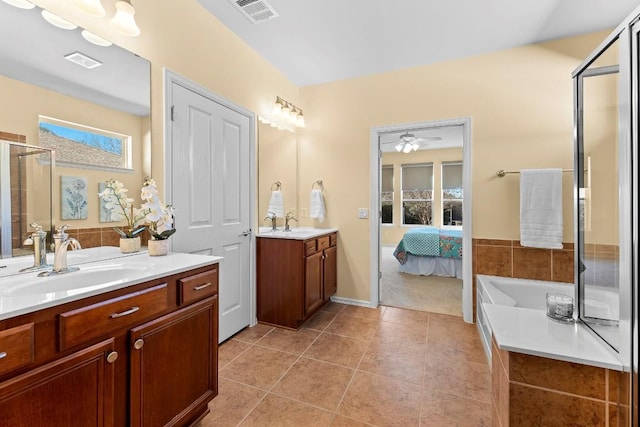 bathroom featuring vanity, tile patterned floors, and plus walk in shower